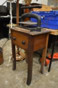 An old cast iron book press on stand.