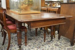 A good 19th century mahogany extending dining table with two leaves.