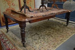 A good 19th century mahogany large extending dining table with two leaves.