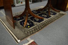 A modern blue ground Bukhara style rug 200cm x 128cm.