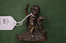 A small bronze model of a young boy on the back of a swan.