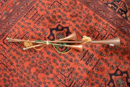 Three copper hunting horns.