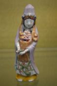 A Japanese Kutani figure of a women.