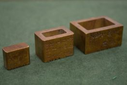 A graduated set of three Chinese bronze seals.