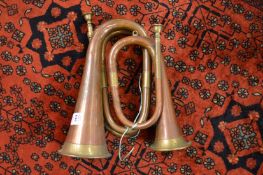 Two copper and brass bugles.