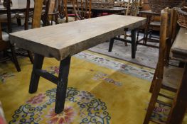 A rustic solid thick plank top trestle table.