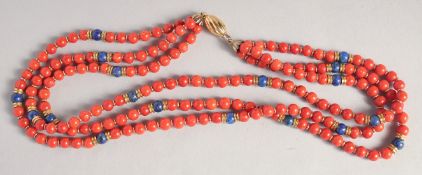 A THREE ROW CORAL NECKLACE with gold clasp.