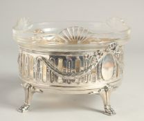 A CONTINTENTAL .800 SILVER AND GLASS CIRCULAR FRUIT BOWL of Adam design supported on four claw feet.