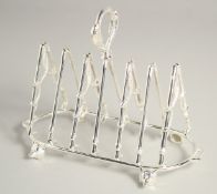 A SILVER PLATED SIX DIVISION TOAST RACK, riding crops and foxes' heads.