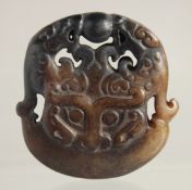A CARVED ARCHAIC JADE PENDANT. 2ins