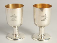 AN EXCELLENT PAIR OF SILVER GOBLETS BY R. J. J. with gilt interior. Griffin crest. 4.75ins high,