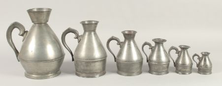 A GOOD SET OF SIX IRISH PEWTER HAYSTACK MEASURES, 1826 - 1840. 2.75ins to 9.5ins.