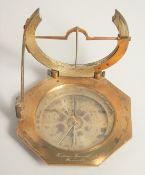 A GEORGIAN OCTAGONAL BRASS TRAVELLING COMPASS with silvered dial. Made in Paris. 3.75ins in a