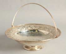 A VICTORIAN SILVER CIRCULAR BASKET with engraved and repousse decoration with headed edge and
