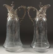 A VERY GOOD PAIR OF GLASS CLARET JUGS with plated mounts and lid. 11.5ins high.