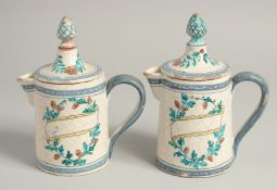 A PAIR OF 19TH CENTURY TIN GLAZE JUGS AND COVERS with pineapple finials. 7.5ins high.