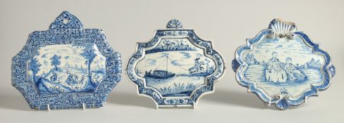 THREE 19TH CENTURY DUTCH BLUE AND WHITE SHAPED PLAQUES, a horse and rider pulling a barge, Boar