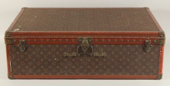 A LOUIS VUITTON SUITCASE. No. 920890, with Louis Vuitton label. Brass lock no 147171. Handle