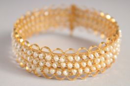 A GOOD GOLD AND THREE ROW SEED PEARL BRACELET.