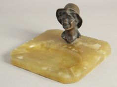 AN ART DECO BRONZE AN ONYX ASHTRAY, head of a boy.
