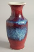 A SMALL FLAMBE STYLE GLAZE PORCELAIN VASE. 15.5cm high.