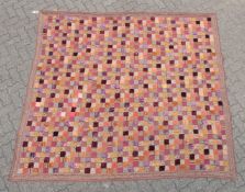 A LARGE PATCHWORK QUILT.