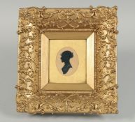A GOOD VICTORIAN GILT FRAMED SILHOUETTE of a lady, head and shoulders. 2.75ins x 2ins.
