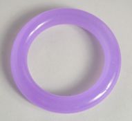 A LILAC JADE BANGLE. 3.25ins diameter.