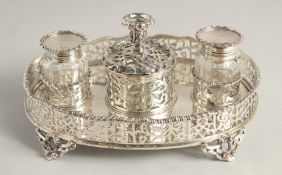 A SUPERB VICTORIAN SILVER OVAL INKSTAND with pierced gallery, two glass top bottles and silver