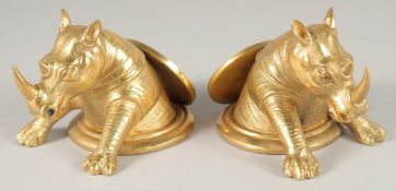 A PAIR OF GILT BRONZE RHINO DESK WEIGHTS. 5ins long.