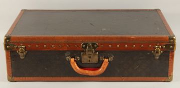 A LOUIS VUITTON SUITCASE. No. 819485, with Louis Vuitton label. From Arthur Gilbert, New York.
