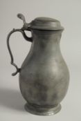 AN 18TH CENTURY PEWTER FLEMISH PEWTER FLAGON AND COVER. 11ins high.