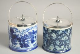 TWO SILVER PLATED AND PORCELAIN CIRCULAR BISCUIT BARRELS AND COVERS.