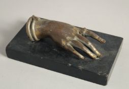AN ITALIAN BRONZE HAND. 5ins long on a black marble base.