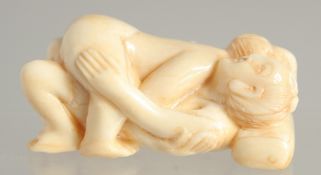 A CARVED BONE EROTIC NETSUKE. 2ins long.