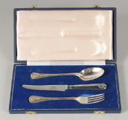 A MAPPIN & WEBB THREE PIECE CHRISTENING SET, spoon, knife & fork in a blue box.
