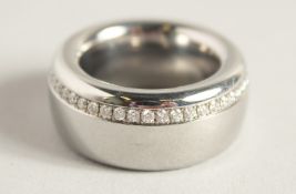 A DESIGNER TITANIUM RING set with diamonds. 27.8gms.