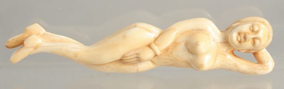 A CARVED BONE NUDE FIGURE 5ins long.