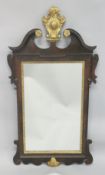A GEORGE III MAHOGANY AND GILDED FRETWORK FRAMED WALL MIRROR, with swan neck pediment, curved and