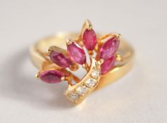 A GOLD DIAMOND AND RUBY FLOWER RING.