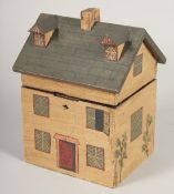 A WOODEN COTTAGE TEA CADDY. 8ins high.