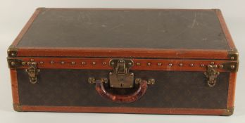A LOUIS VUITTON SUITCASE. No. 82154 with Louis Vuitton label. Saks & Co., New York label. Pull-out