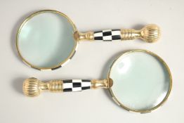 A PAIR OF MAGNIFYING GLASSES with chequered handles (2).