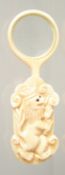 A CARVED BONE LOOKING GLASS.