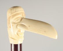 A CARVED BONE HANDLE WALKING STICK, 'LONG NOSE'. 3ft long.