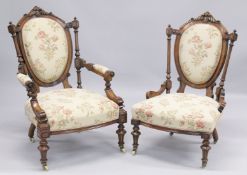 A GOOD VICTORIAN CARVED WALNUT NURSING AND MATCHING ARMCHAIR with padded back, arms and seat,
