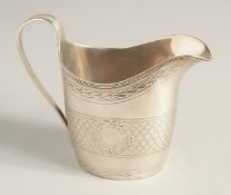A GEORGE III SILVER CREAM JUG with reeded edge and engraved body. London 1795.