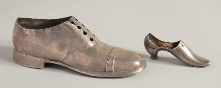 A LARGE SILVER SHOE, 4.75ins long, Birmingham 1903, and another, 2.5ins long. Birmingham 1938 (2).