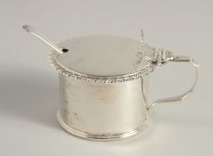 A SILVER CIRCULAR DRUM MUSTARD with gadrooned edge, spoon, and sapphire blue liner. Chester 1897.