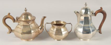 A THREE PIECE OCTAGONAL TEA SET, tea pot, hot water jug and sugar basin. Birmingham, mark rubbed,